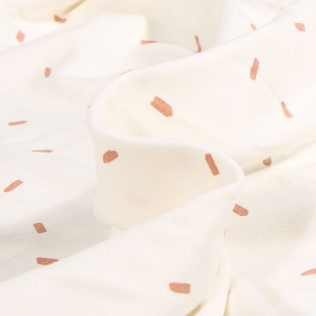 Tissu Jersey Coton Conféttis cassonade sur fond Blanc cassé