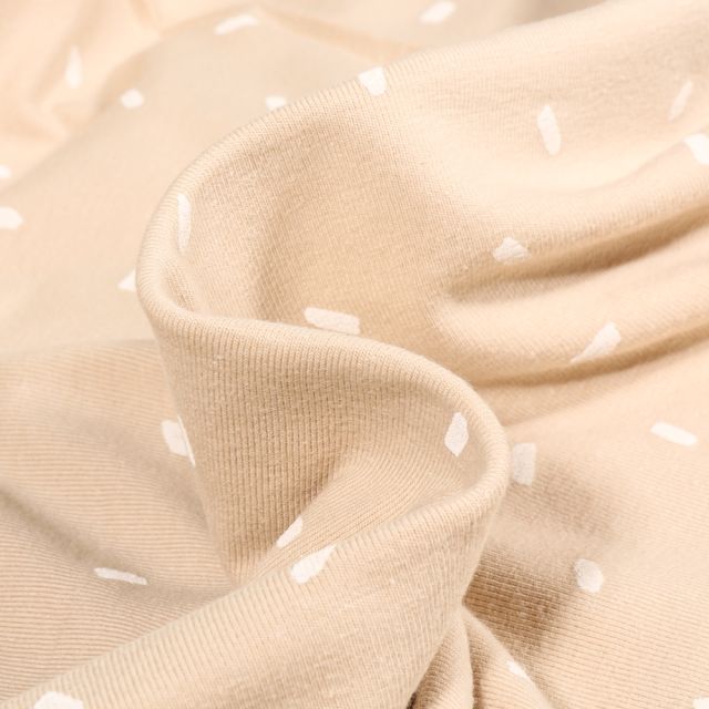 Tissu Jersey Coton Confettis blancs sur fond Beige