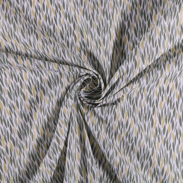 Tissu Coton imprimé Feuilles vertes et jaunes sur fond Blanc - Par 10 cm