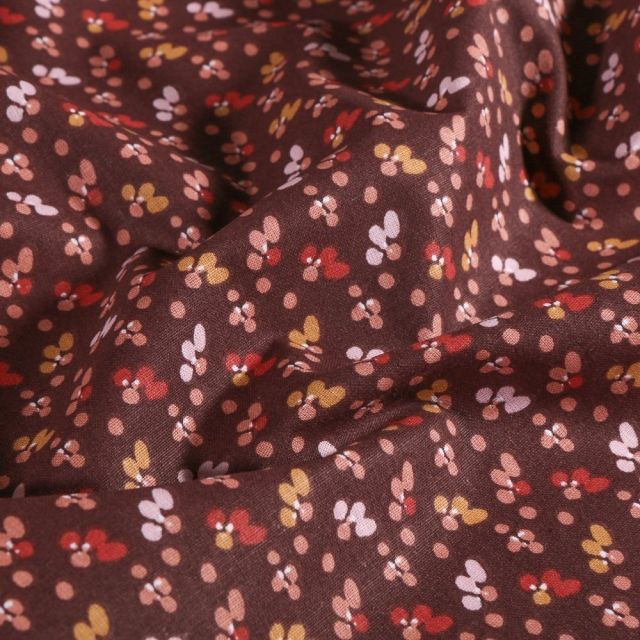 Tissu Coton imprimé Arty Petites pétales de fleurs ocre et rose sur fond Prune - Par 10 cm
