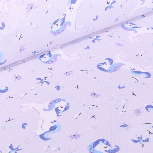 Tissu Coton imprimé Arty Licornes et petites fleurs sur fond Bleu lilas
