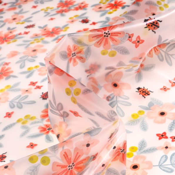 Tissu Imperméable Fleurs roses sur fond Transparent - Par 10 cm