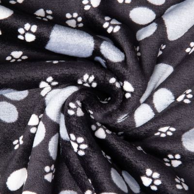 Tissu Doudou imprimé empreintes pattes sur fond Noir - Par 10 cm