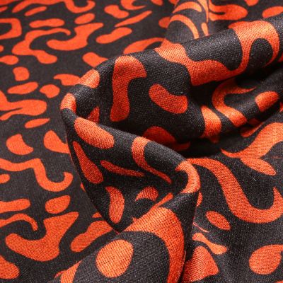 Tissu Maille polyviscose Anna Motifs abstraits orange sur fond Noir - Par 10 cm