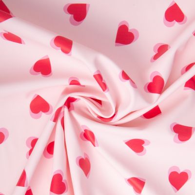 Tissu Imperméable imprimé Coeur Popheart sur fond Rose pâle - Par 10 cm