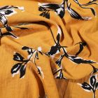Tissu Viscose texturé Feuilles noires et blanches sur fond Jaune moutarde - Par 10 cm