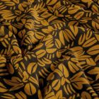 Tissu Sweat léger French Terry Emily feuillages stylisés Moutarde sur fond Noir