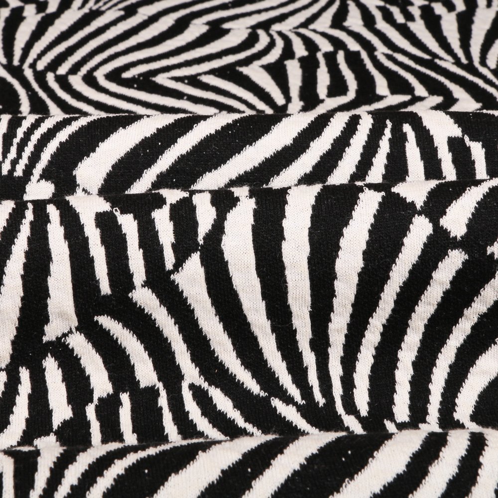 Tissu Gianni Maille Extensible Noir Vagues tigrés Blanches
