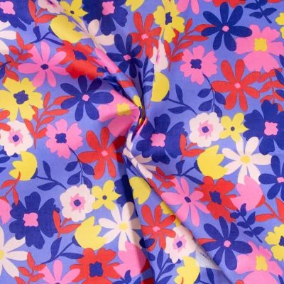 Tissu Coton enduit Poppy Fleurs rouges et jaunes sur fond Bleu - Par 10 cm