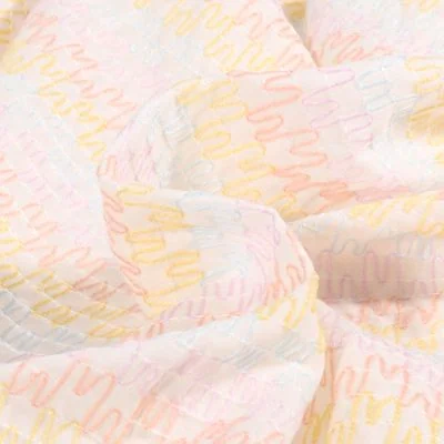 Tissu Voile de Coton brodé Zig zag pastels sur fond Blanc - Par 10 cm