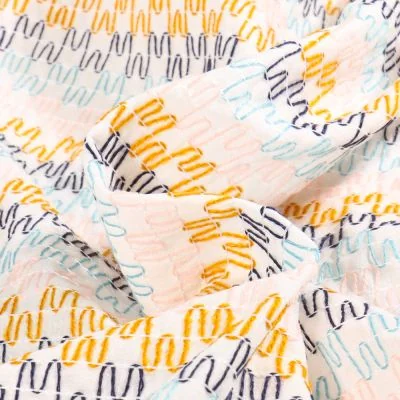 Tissu Voile de Coton brodé Zig zag colorés sur fond Blanc - Par 10 cm