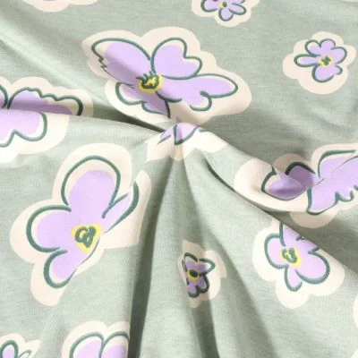 Tissu Jersey Polycoton Poppy Fleurs lilas sur fond Vert menthe - Par 10 cm