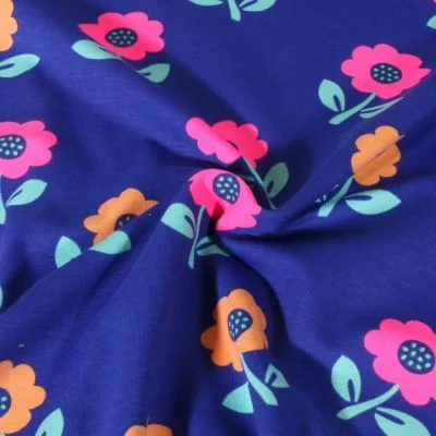 Tissu Jersey Coton Poppy Fleurs oranges et rose fluo sur fond Bleu roi - Par 10 cm