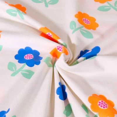 Tissu Jersey Coton Poppy Fleurs bleues et orange fluo sur fond Blanc - Par 10 cm