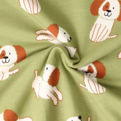 Tissu Sweat léger envers molletonné Oscar chiots Blancs sur fond Vert amande - Par 10 cm