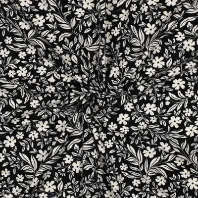 Tissu Jersey Coton imprimé Petites Fleurs Blanches sur fond Noir - Par 10 cm