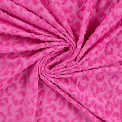 Tissu Maille motif léopard éponge sur fond Rose fuchsia - Par 10 cm