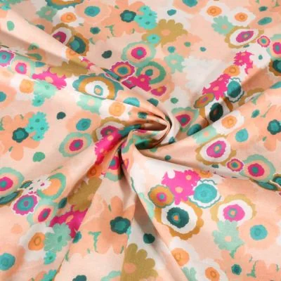 Tissu Voile de Coton digital Fleurs colorées sur fond Pêche - Par 10 cm