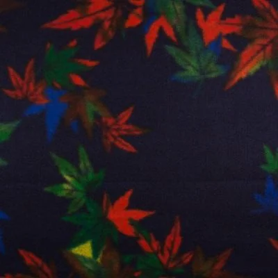 Tissu Caban Laine Feuilles orange et vertes sur fond Bleu marine - Par 10 cm