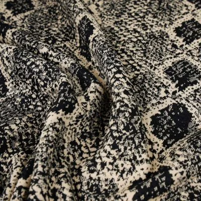 Tissu Maille Jacquard Reptiles beige sur fond Noir - Par 10 cm