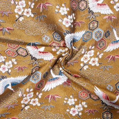 Tissu Jacquard d&#039;ameublement tissé teint Grues sur fond Or - Par 10 cm