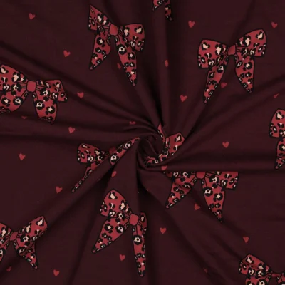 Tissu Sweat léger French Terry Manon noeuds et coeurs Rouge sur fond Bordeaux foncé - Par 10 cm