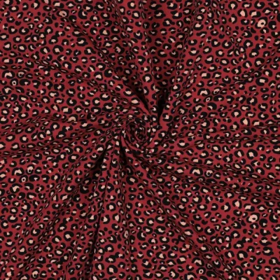 Tissu Sweat léger French Terry Léopard Noir et Ecru sur fond Rouge - Par 10 cm