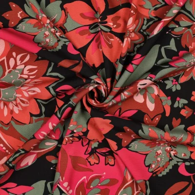 Tissu Viscose élasthanne stretch Grandes fleurs Orange et Vert sur fond Noir - Par 10 cm