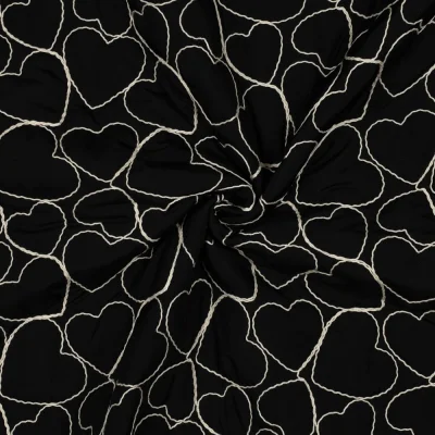 Tissu Matelassé Coeurs brodés Blanc sur fond Noir - Par 10 cm