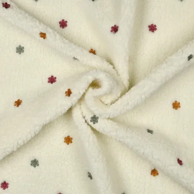 Tissu Fausse fourrure Mouton Teddy petites fleurs brodées sur fond Ecru - Par 10 cm
