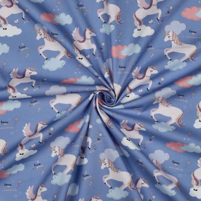 Tissu Popeline de Coton Zelhia licornes magiques sur fond Bleu - Par 10 cm