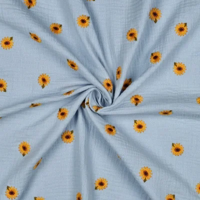 Tissu Double gaze de Coton tournesols brodés sur fond Bleu - Par 10 cm