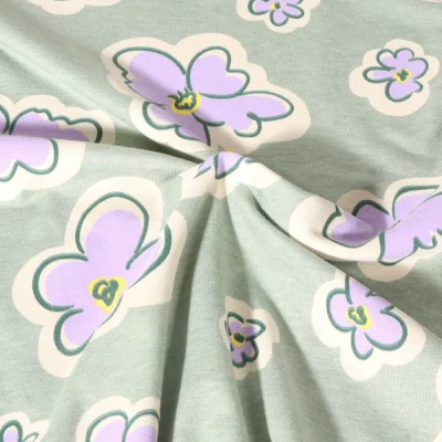 Tissu Jersey Polycoton Poppy Fleurs lilas sur fond Vert menthe - Par 10 cm