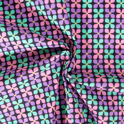 Tissu Coton enduit Poppy Fleur menthe et mauve sur fond Noir - Par 10 cm