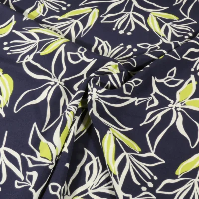 Tissu Stretch imprimé Motifs floraux blanc et vert sur fond Bleu marine - Par 10 cm