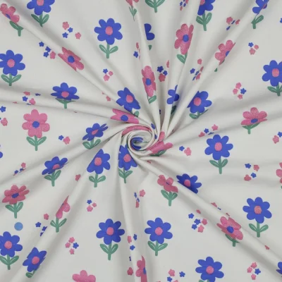 Tissu Jersey Coton imprimé Fleurs pailletées Rose et bleu sur fond Blanc - Par 10 cm