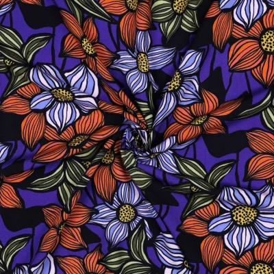 Tissu Viscose EcoVero tapis fleurs Bleu cobalt, Vert et Orange sur fond Noir - Par 10 cm