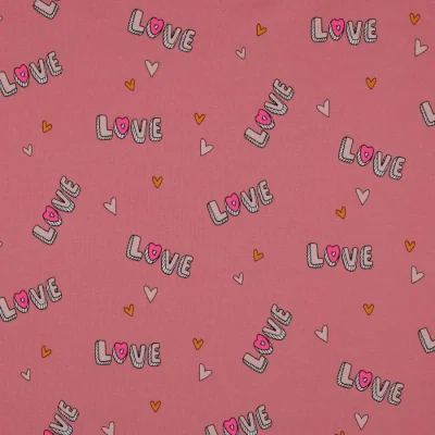 Tissu Jersey Coton Love sur fond Vieux rose - Par 10 cm