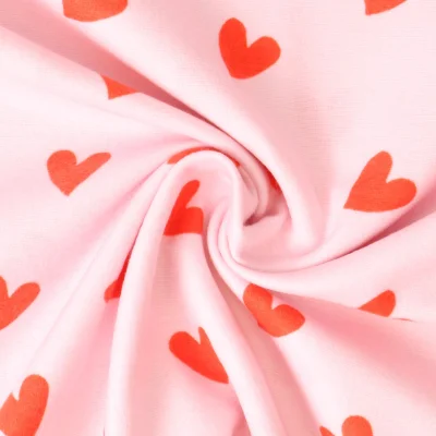 Tissu Flanelle de Coton  Caline cœurs Rouges sur fond Rose - Par 10 cm