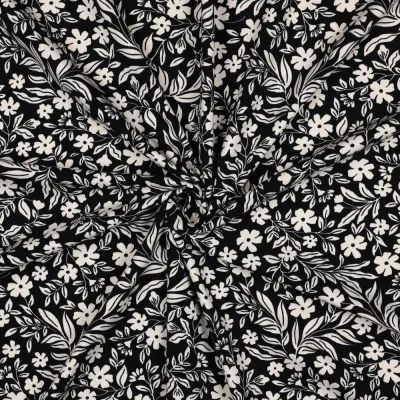 Tissu Jersey Coton imprimé Petites Fleurs Blanches sur fond Noir - Par 10 cm