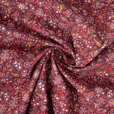 Tissu Popeline de Coton motifs paisleys floraux sur fond Bordeaux - Par 10 cm