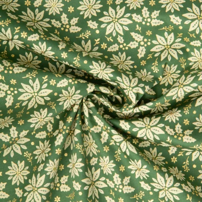 Tissu Coton imprimé fleurs dorées de noël sur fond Vert - Par 10 cm