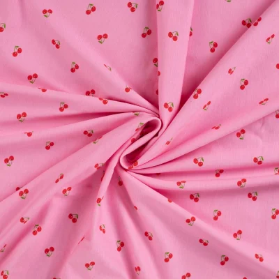 Tissu Jersey Coton imprimé Cerises rouges sur fond Rose - Par 10 cm