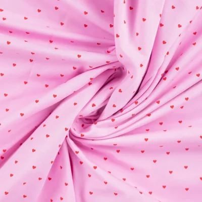 Tissu Jersey Coton Rosalie Petits coeurs framboise sur fond Rose bonbon - Par 10 cm