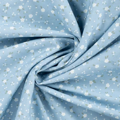 Tissu Popeline de Coton Charlotte petites fleurs sur fond Bleu ciel - Par 10 cm