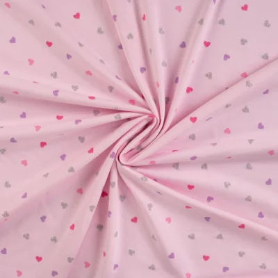 Tissu Jersey Coton Coeurs roses, lilas et argent pailleté sur fond Rose pâle - Par 10 cm