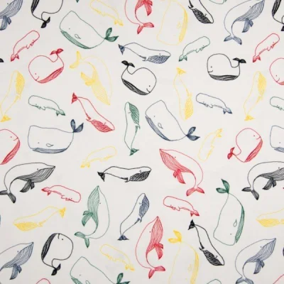 Tissu Jersey Coton Baleines Multicolores sur fond Blanc - Par 10 cm