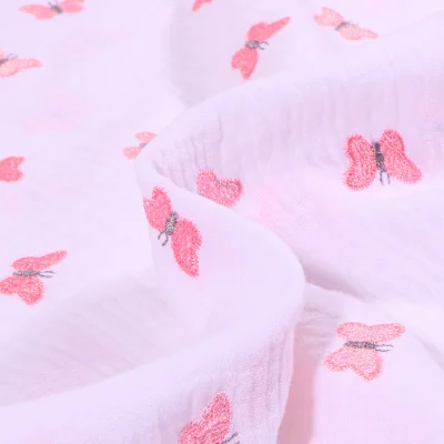 Tissu Double gaze Papillons brodés sur fond Blanc - Par 10 cm