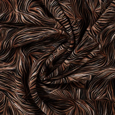 Tissu Viscose twill feuillage graphique Cognac et Noisette sur fond Noir - Par 10 cm