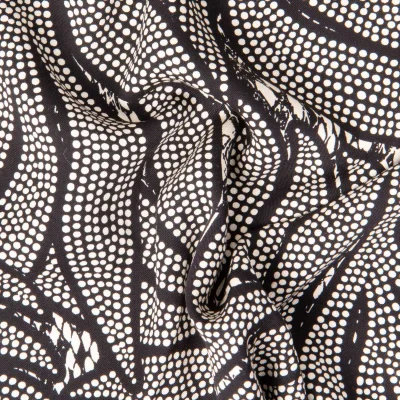 Tissu Viscose Twill EcoVero feuilles en pointillés sur fond Noir - Par 10 cm